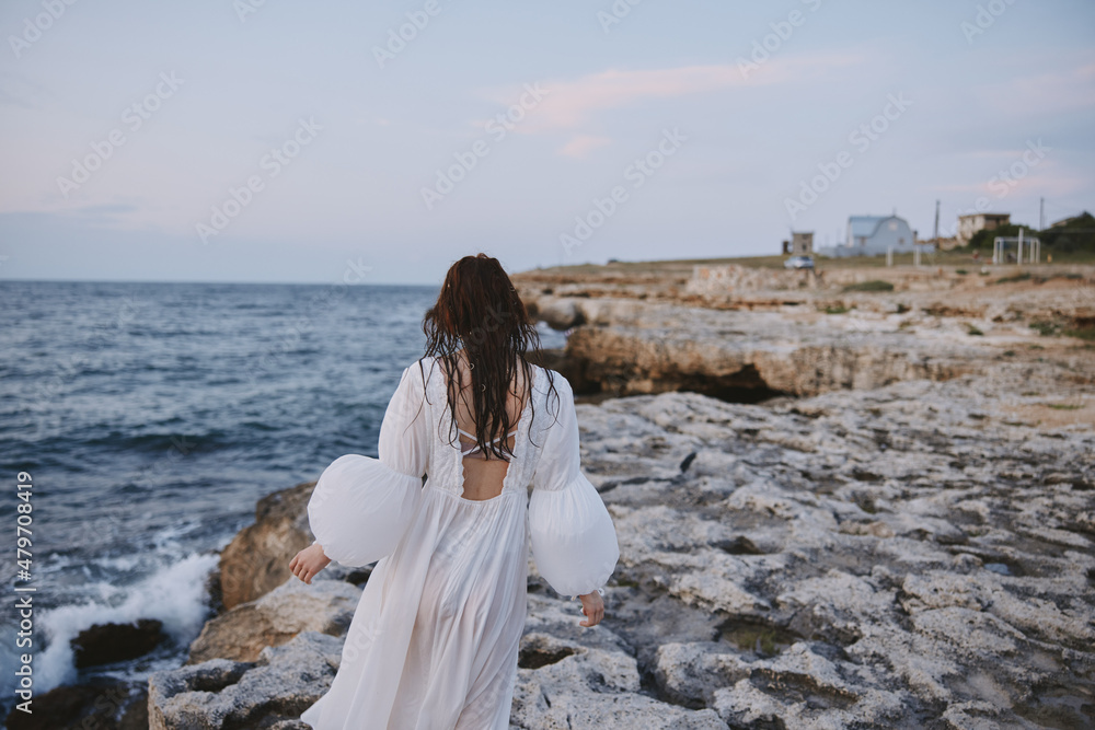 Woman in white dress summer walk ocean landscape travel Woman in white dress summer walk ocean landscape travel