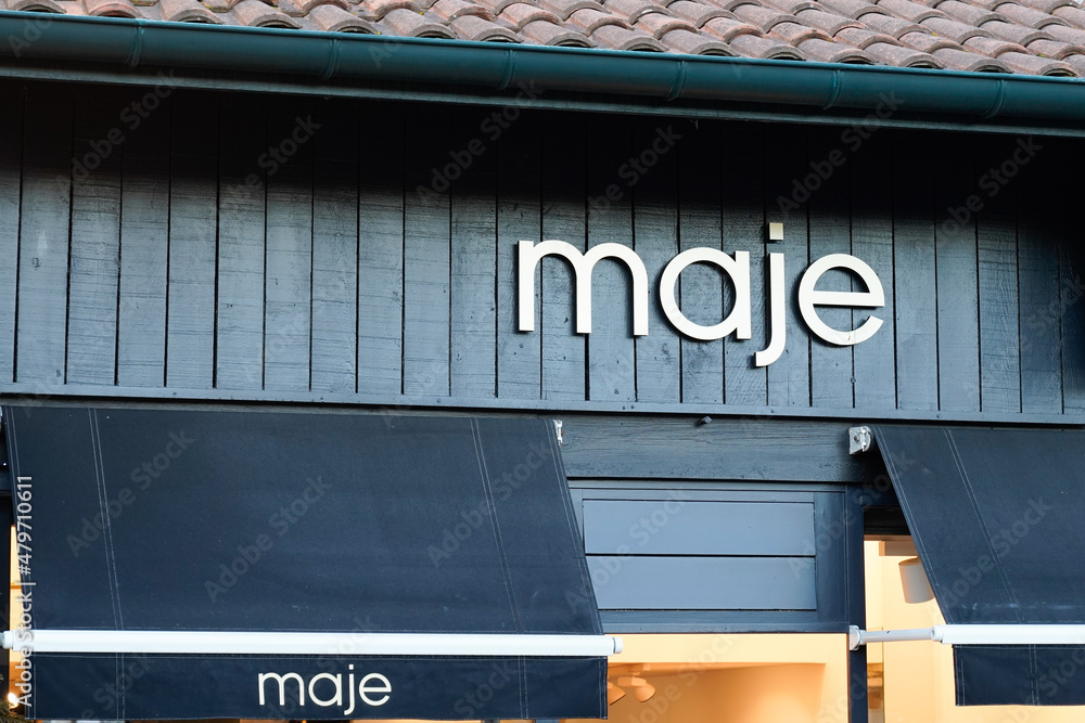 Maje logo brand boutique and text sign clothing store facade French fashion  shop Stock Photo | Adobe Stock