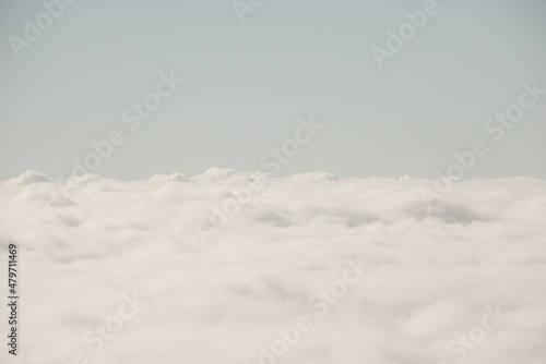 Scenery seen from airplane above the white clouds in the sky photo