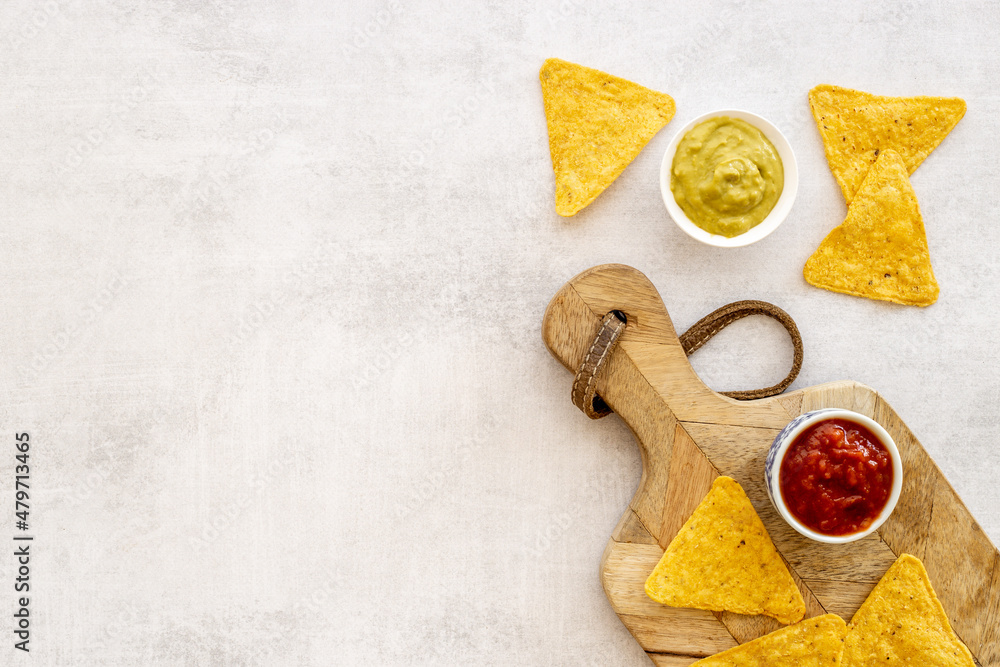 Snack for party corn nachos with salsa and guacamole sauces Snack for party corn nachos with salsa and guacamole sauces