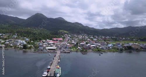 4K Aerial Footage View to the Green and Natural Portsmouth Coastline and Dock of the Dominica Island, Caribbean Sea photo