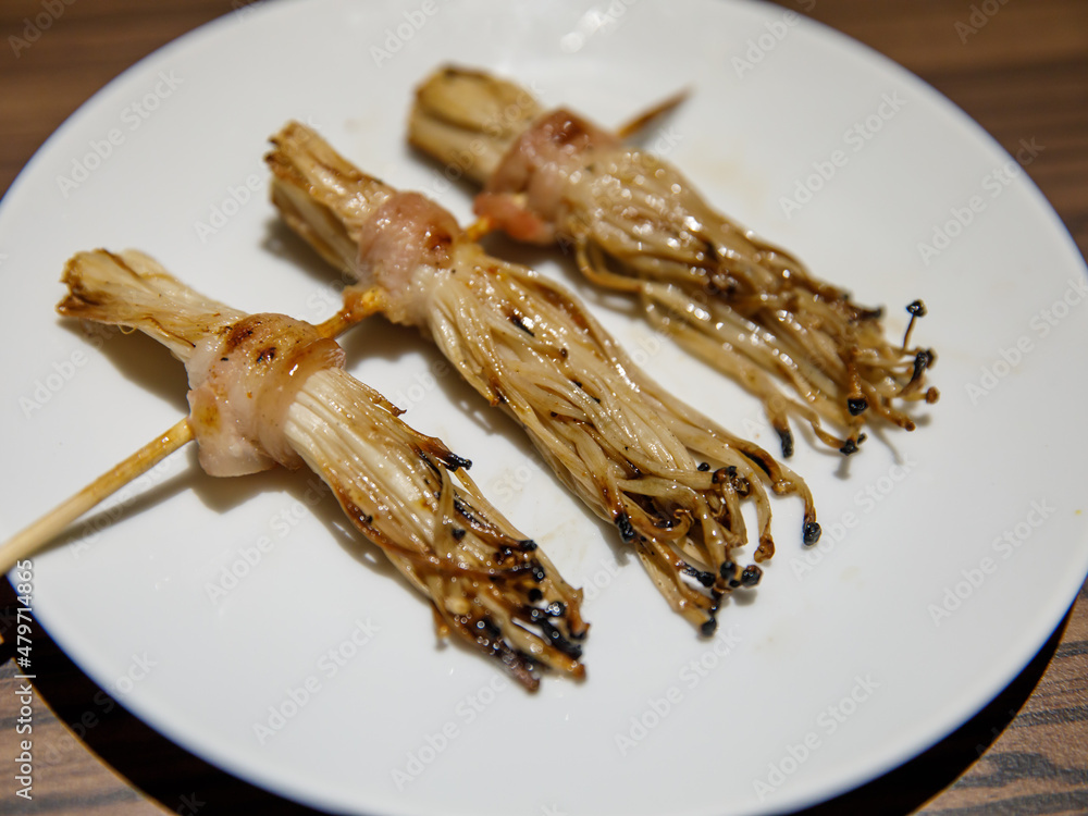 Bacon roll with Golden Needle Mushroom, Thailand Phuket street stall BBQ sticks. Enokitake Mushroom wrapped bacon, on skewers barbecue grilled in night market local street food. Bacon roll with Golden Needle Mushroom, Thailand Phuket street stall BBQ sticks. Enokitake Mushroom wrapped bacon, on skewers barbecue grilled in night market local street food.