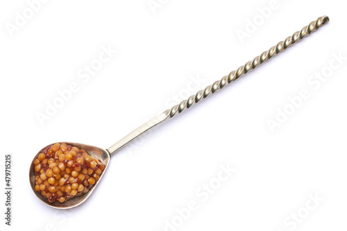 Spoon of Classic Dijon mustard sauce isolated on white background