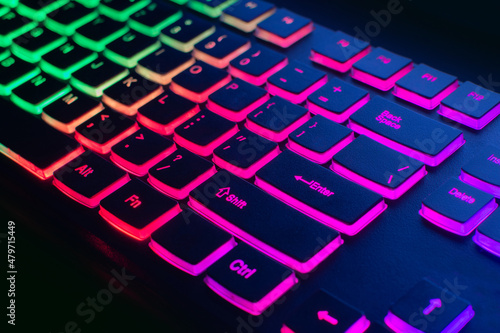 RGB gaming keyboard. Bright colorful keyboard  soft focus. Keyboard with RGB light  blurred background. Close-up.