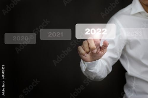 Fototapeta Naklejka Na Ścianę i Meble -  Businessman hands touch on white 2022 virtual screen, new year concept.