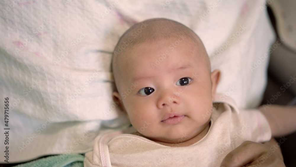 Adorable newborn baby with yawning and looking at camera, happy face. Little innocent new infant child in first day of life. Mother day concept. Adorable newborn baby with yawning and looking at camera, happy face. Little innocent new infant child in first day of life. Mother day concept.