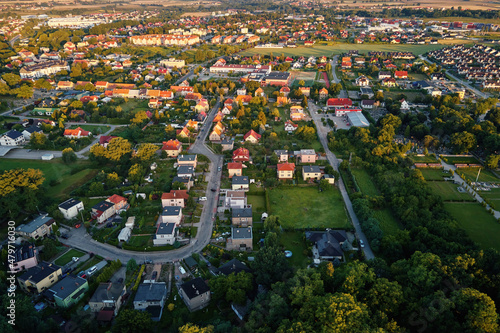 Fototapeta Naklejka Na Ścianę i Meble -  Aerial view of suburban neighborhood, Residential district with buildings and streets at small european town at sunset