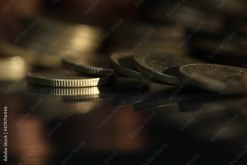 A vertical shot of a pile of golden coins and copper coins. A vertical shot of a pile of golden coins and copper coins.