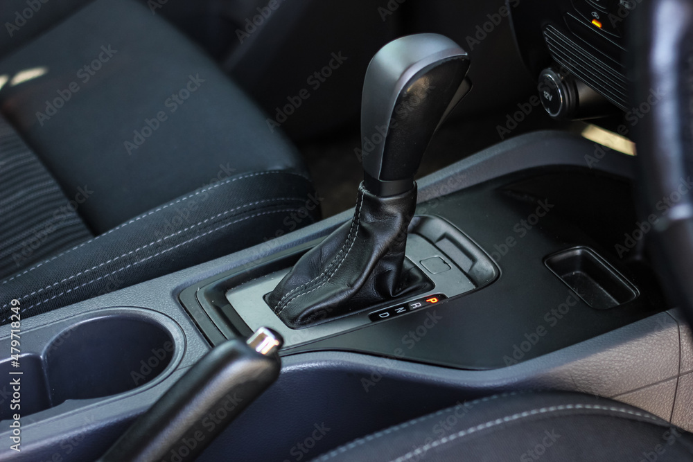 automatic transmission shift selector in the car interior. Closeup a manual shift of modern car gear shifter. automatic transmission shift selector in the car interior. Closeup a manual shift of modern car gear shifter.