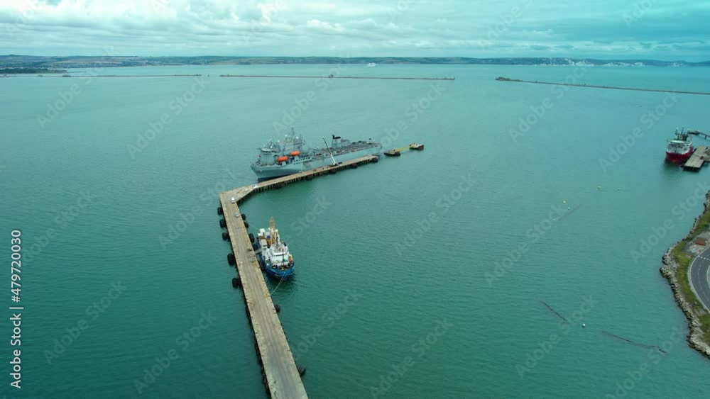 Aerial view over Argus Royal fleet auxiliary British military floating hospital ship docked at harbour breakwater Aerial view over Argus Royal fleet auxiliary British military floating hospital ship docked at harbour breakwater