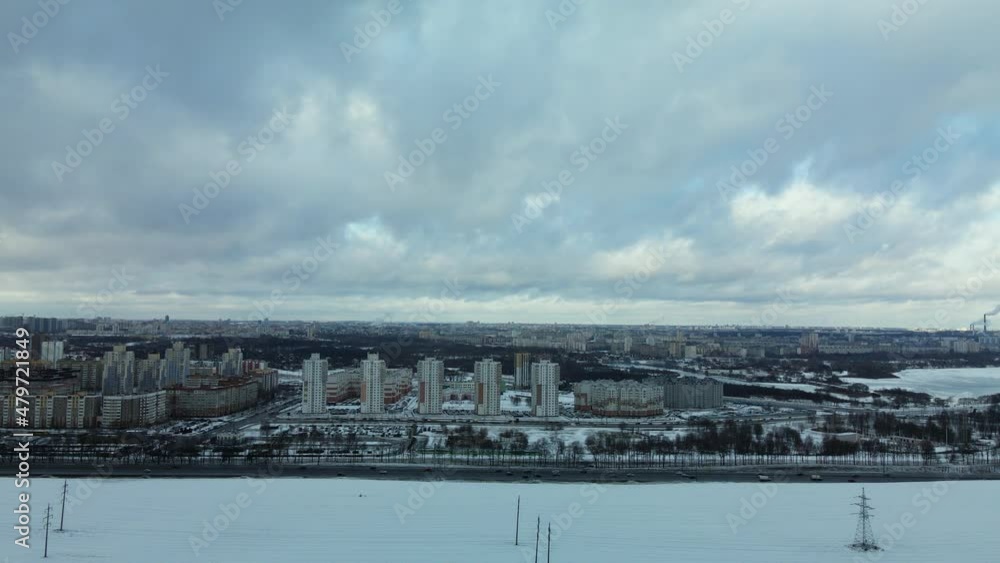 Flying over a snowy field. The city is visible on the horizon. Aerial photography Flying over a snowy field. The city is visible on the horizon. Aerial photography