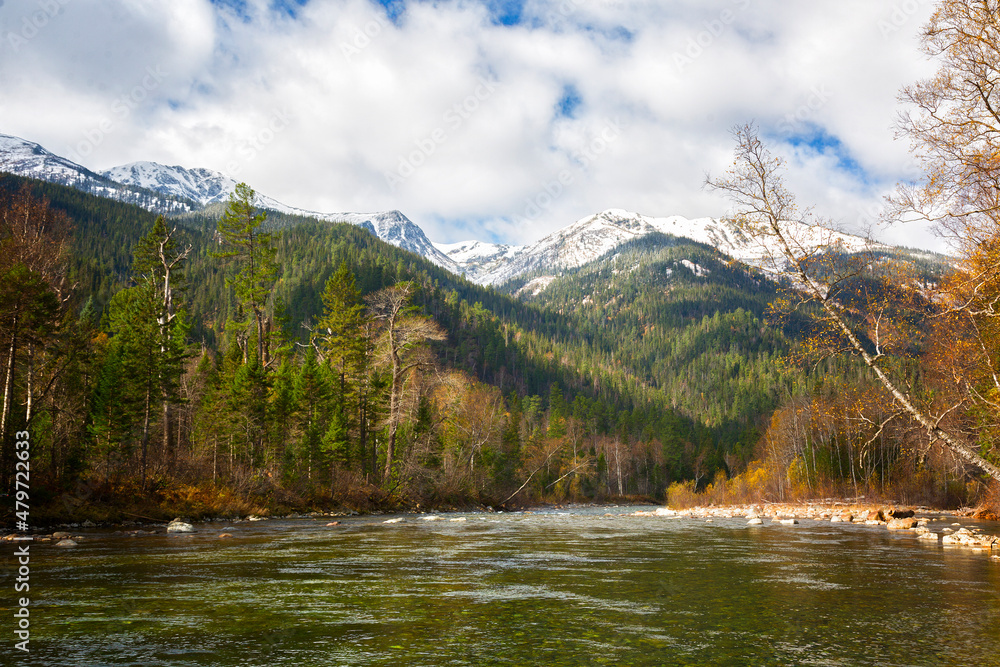 Autumn landscape with a river and snow-capped mountains, Russia, Khamar-Daban
