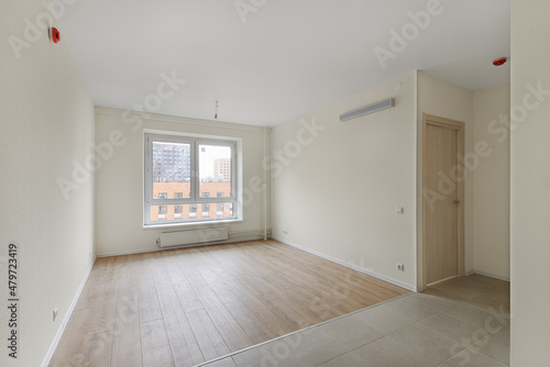 Empty room after repairs in an apartment building. Fresh renovated room with wooden and tiled floors © FedotovAnatoly