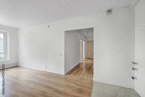 Empty room after repairs in an apartment building. Fresh renovated room with wooden and tiled floors