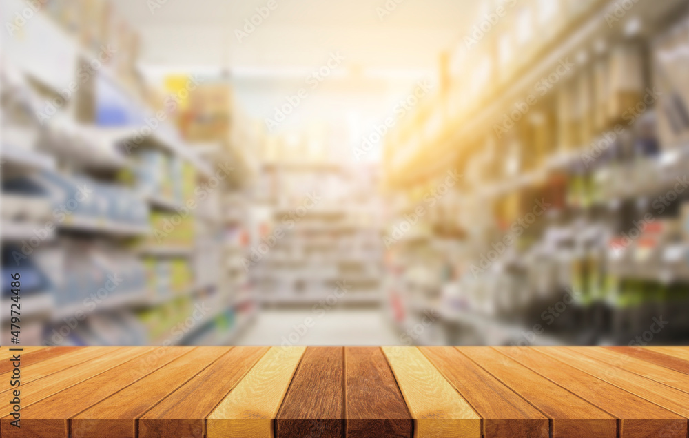 Wooden table for placing products for advertising. with blurred background of supermarket shelves.