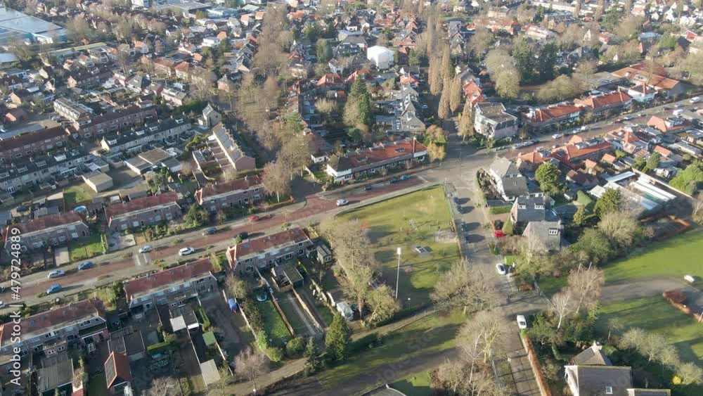 Aerial of a delivery van driving through a calm and beautiful suburban neighborhood Aerial of a delivery van driving through a calm and beautiful suburban neighborhood