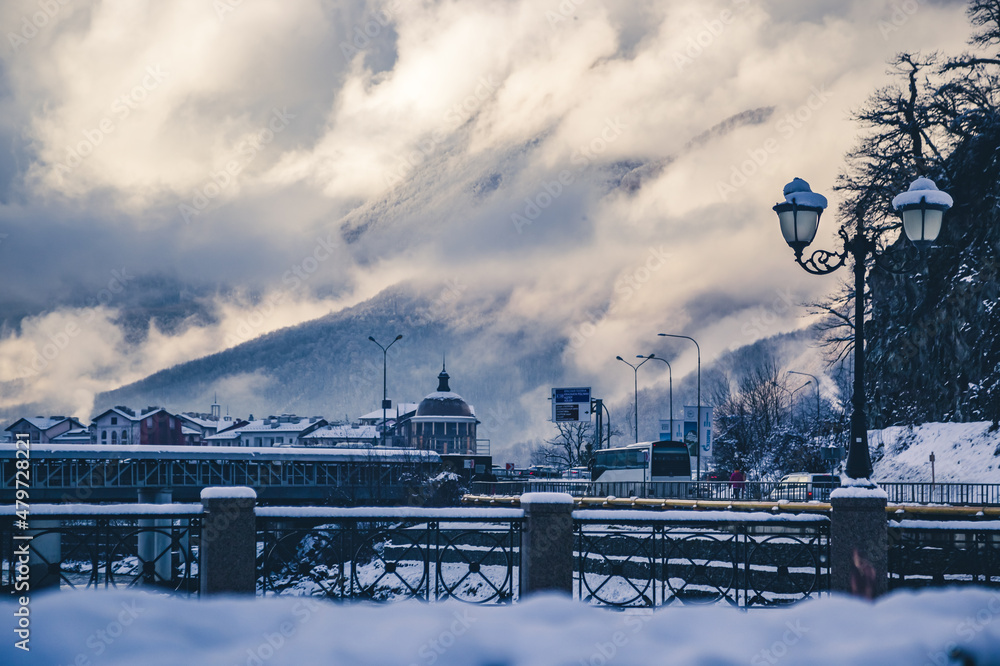 landscape of the city against the background of high mountains in the snow, cold and winter. landscape of the city against the background of high mountains in the snow, cold and winter.