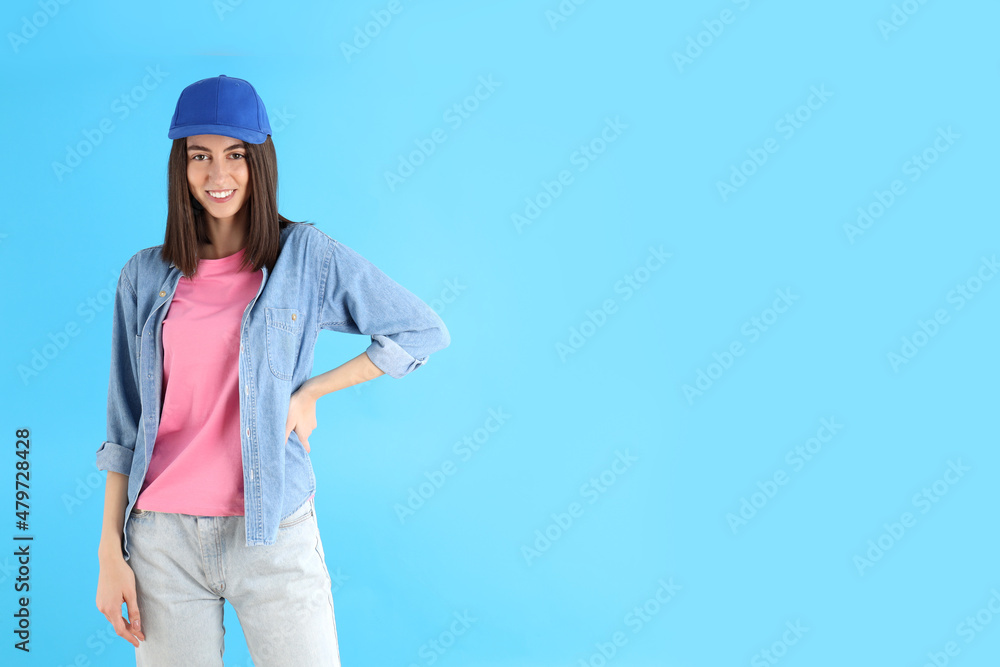 Attractive girl in cap on blue background Attractive girl in cap on blue background