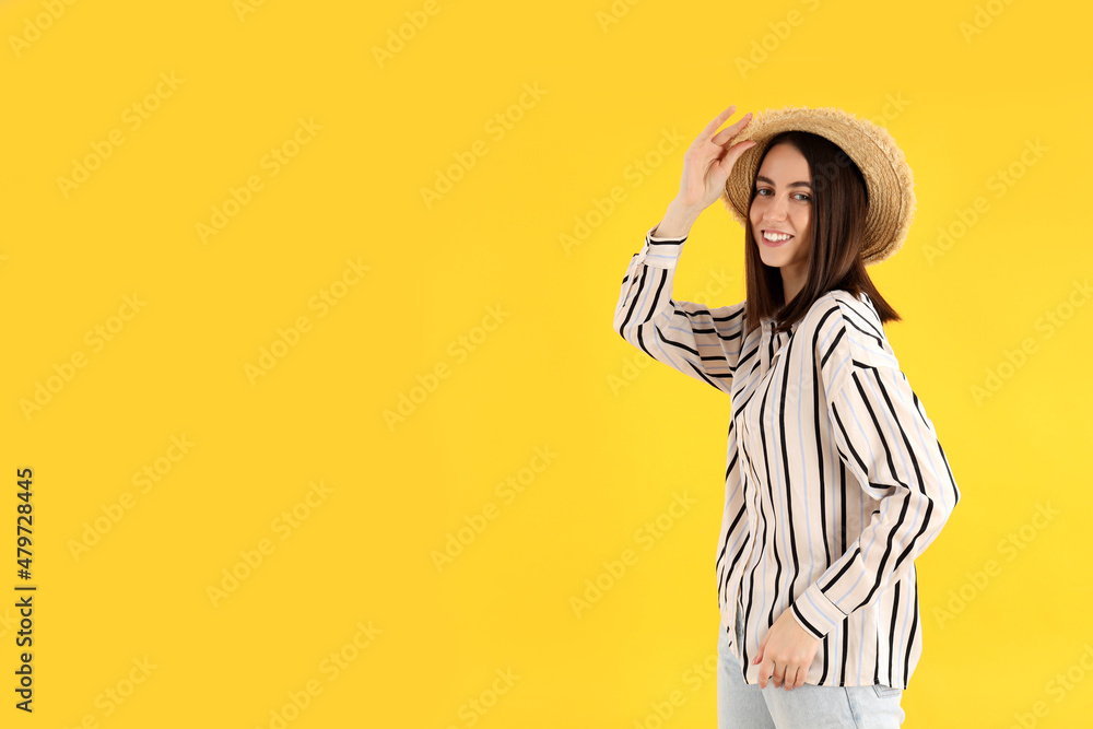 Young attractive girl in shirt and hat on yellow background Young attractive girl in shirt and hat on yellow background