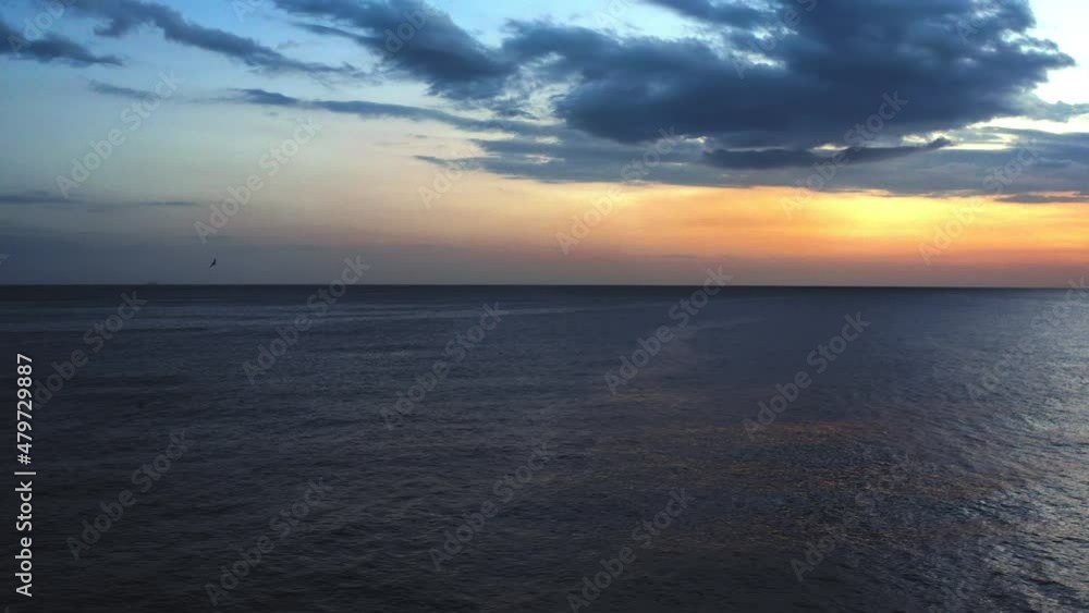 Flying seagulls over the sea at dusk. Drone footage Flying seagulls over the sea at dusk. Drone footage