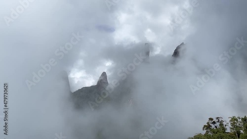 Rising clouds slowly obscuring the view of Postcard panorama landscape of Brazilian mountain range Serra dos Orgaos in Teresopolis, Rio de Janeiro. 60fps normal speed photo