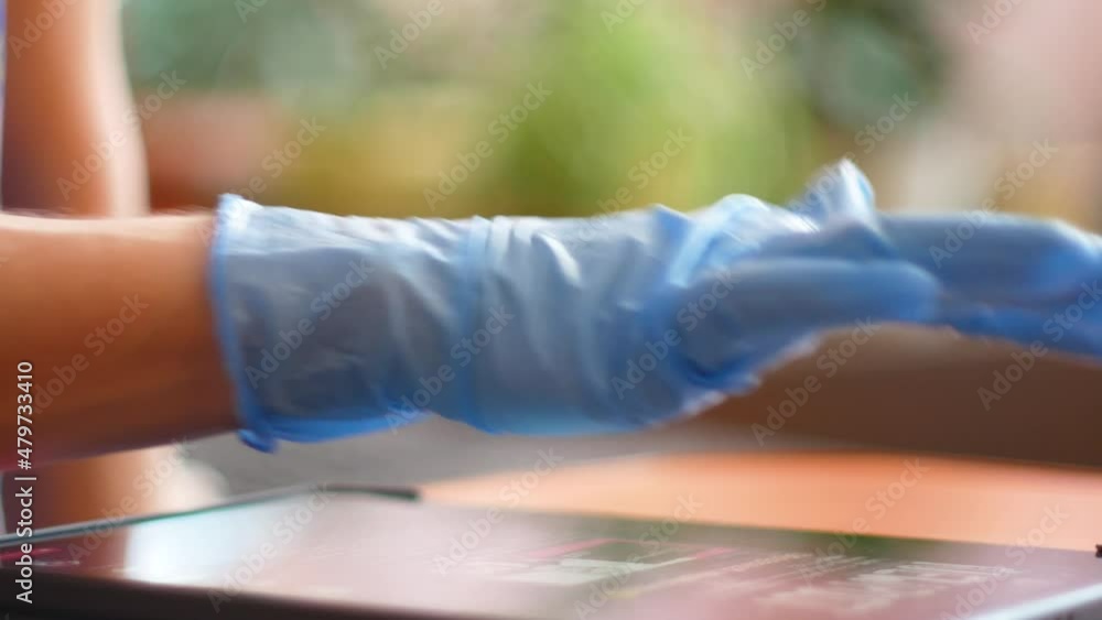 A hand in a blue glove touches a modern digital tablet. Concept on a medical or research theme.Modern devices for medical professionals.doctor fills out a medical form, consults a patient online A hand in a blue glove touches a modern digital tablet. Concept on a medical or research theme.Modern devices for medical professionals.doctor fills out a medical form, consults a patient online