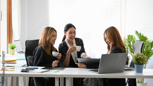 A group of a happy businesswomen or colleagues having a fun conversations. © bongkarn