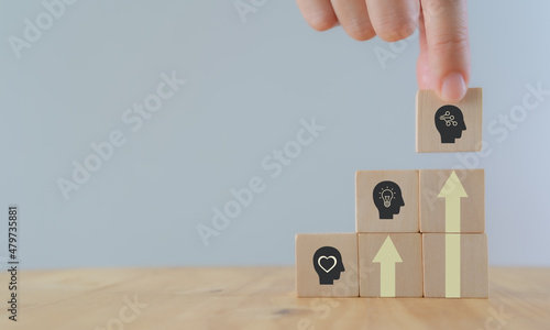 Skills development concept. New skills for technology evolution. Soft, thinking,digital skill. Hand holds wooden cubes with digital skill icon on white background, copy space. Reskilling, upskilling. photo