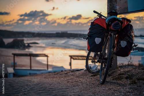 Bicycle with bags by the Almograve beach, Alentejo, Portugal photo