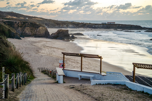 Nice Almograve sandy beach with cliffs at sunset, Portugal
