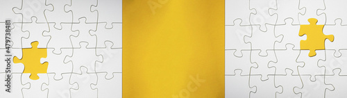 Empty white details of puzzle on yellow background banner panorama, with space for text