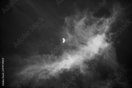 Billede på lærred Black and white image of a cirrus cloud with half moon in the center