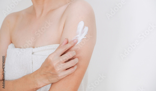 Woman applying cream,lotion on arm with white background, Beauty concept.