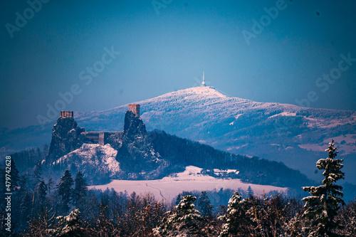 landscape view with ruin of castle Trosky with mountain Jested at background in winter