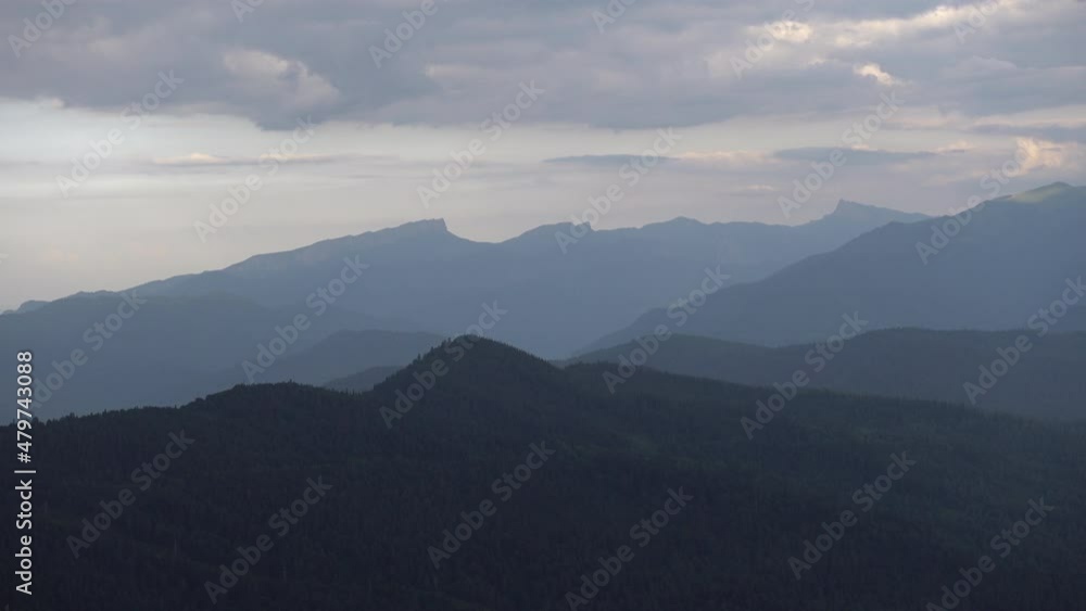 Silhouettes of mountains against the background of the evening sky. Caucasian State Natural Biosphere Reserve named after Kh.G. Shaposhnikov. Lago-Naki plateau. Russia. Silhouettes of mountains against the background of the evening sky. Caucasian State Natural Biosphere Reserve named after Kh.G. Shaposhnikov. Lago-Naki plateau. Russia.