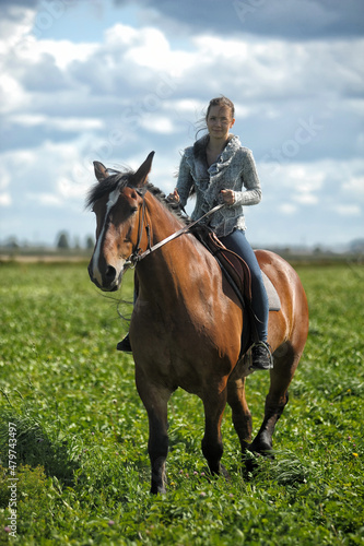 teenager girl with a horse in the field © Evdoha