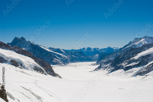 A breathtaking view of the valley and swiss mountains from Jungfrau, the top of Europe with deep blue sky
