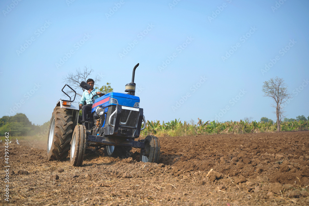 Indian farmer working with tractor in agriculture field. Indian farmer working with tractor in agriculture field.