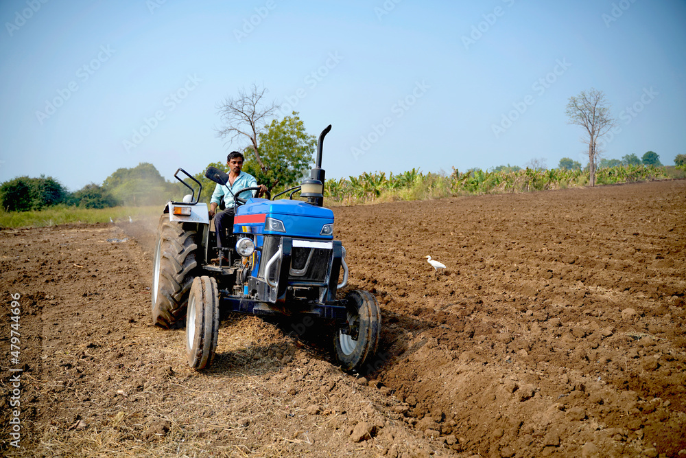 Indian farmer working with tractor in agriculture field. Indian farmer working with tractor in agriculture field.