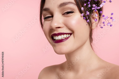 Obraz na plátně Happy  pretty girl with perfect make up, glowing healthy skin, bare shoulders, lilac flowers in hairs