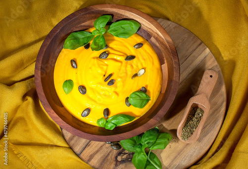 Pumpkin soup with cream on dark wooden background Top view Copy space