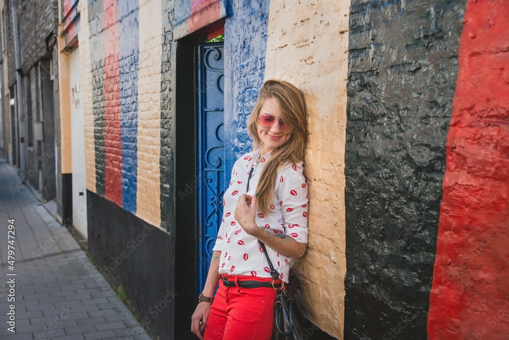 Young Woman Leaning on Colorful Wall