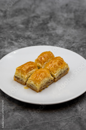 Walnut baklava on a dark background. Traditional Turkish cuisine delicacies. Close-up.