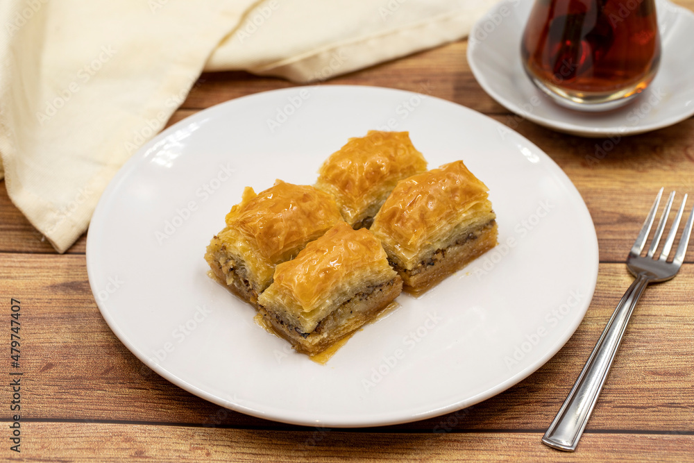 Walnut baklava on a wooden background. Traditional Turkish cuisine delicacies. Close-up.