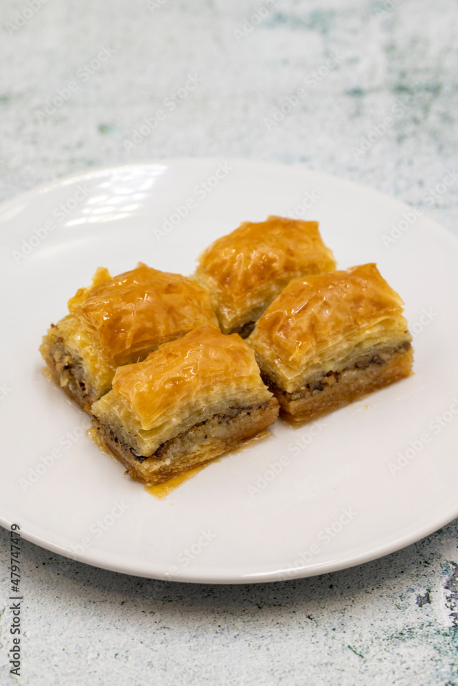 Walnut baklava on a stone background. Traditional Turkish cuisine delicacies. Close-up.