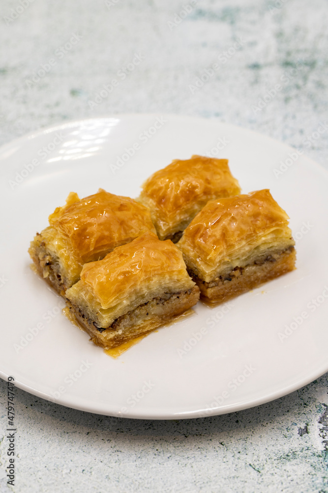 Walnut baklava on a stone background. Traditional Turkish cuisine delicacies. Close-up. Walnut baklava on a stone background. Traditional Turkish cuisine delicacies. Close-up.