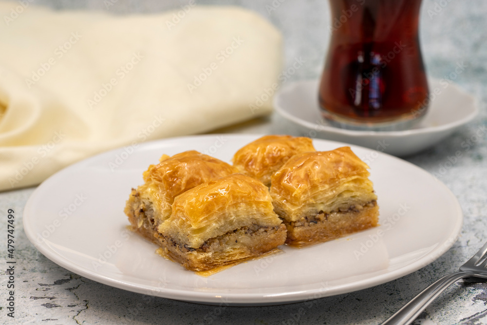 Walnut baklava on a stone background. Traditional Turkish cuisine delicacies. Close-up. Walnut baklava on a stone background. Traditional Turkish cuisine delicacies. Close-up.