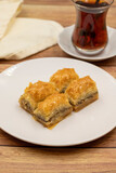 Walnut baklava on a wooden background. Traditional Turkish cuisine delicacies. Close-up.