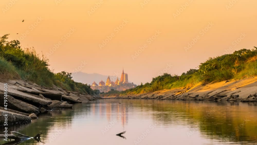 Time lapse of Tiger Cave Temple or Wat Tham Suaor Wat Tham Sua, Kanchanaburi, Thailand is a popular place for tourists. View from the canal at sunset unseen and amazing Time lapse of Tiger Cave Temple or Wat Tham Suaor Wat Tham Sua, Kanchanaburi, Thailand is a popular place for tourists. View from the canal at sunset unseen and amazing