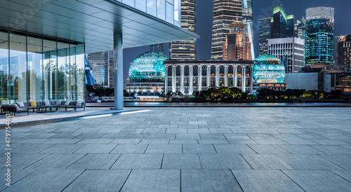 Empty square floor and modern city buildings in Shanghai at night, China.